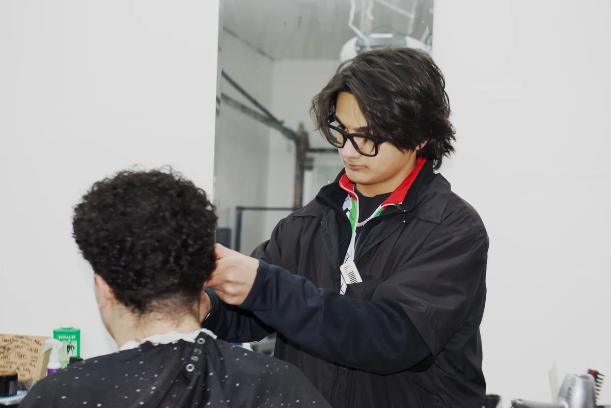 Barber shaping a client's haircut